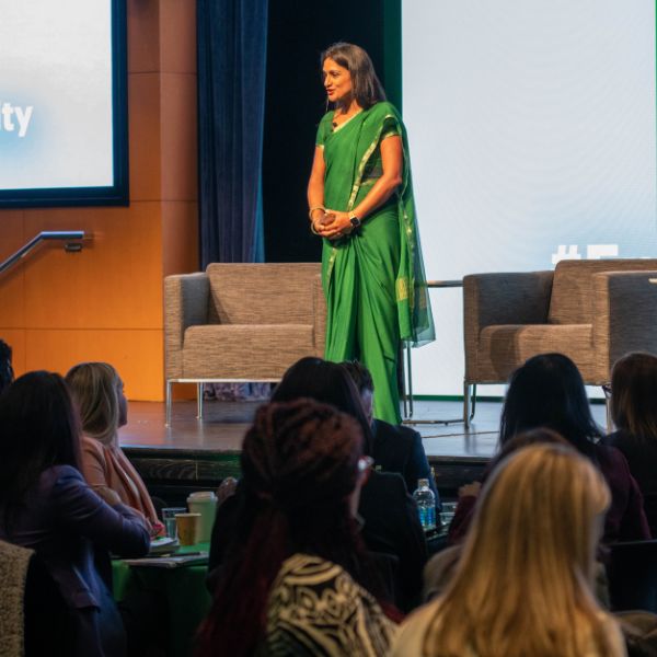 mom executive leader ankana carpenter delivering keynote presentation to crowd of women